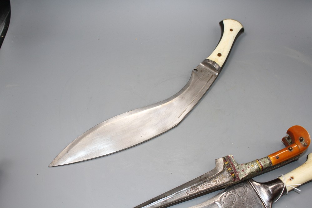 An Indian kukri c.1900, blade 31cms integral with hilt, layered ivory and horn grips, nickel pommel,